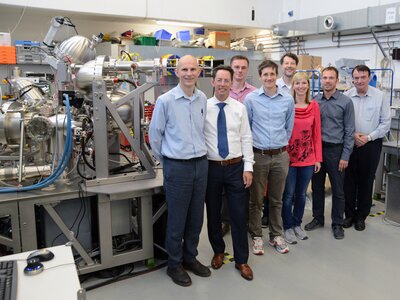 A group of Scienta Omicron and School of Chemistry, University of Bristol researchers standing with the NanoESCA System.  | © University of Bristol 