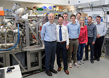 A group of Scienta Omicron and School of Chemistry, University of Bristol researchers standing with the NanoESCA System.  | © University of Bristol 
